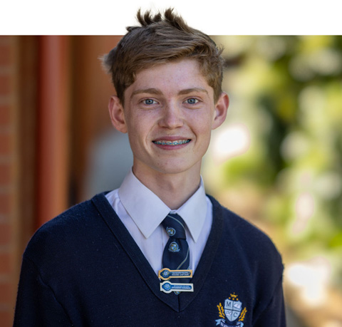 Boy standing smiling at camera